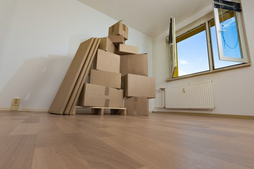 Residential moving team carrying furniture in Friern Barnet